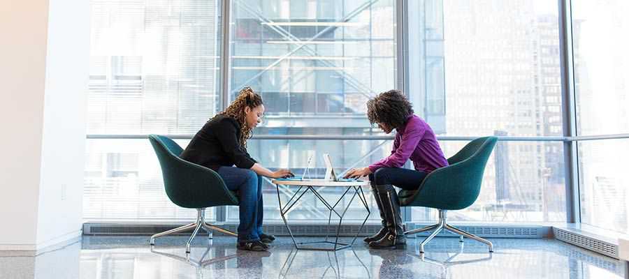 Two people using computers.