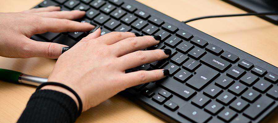 A person typing on a keyboard.