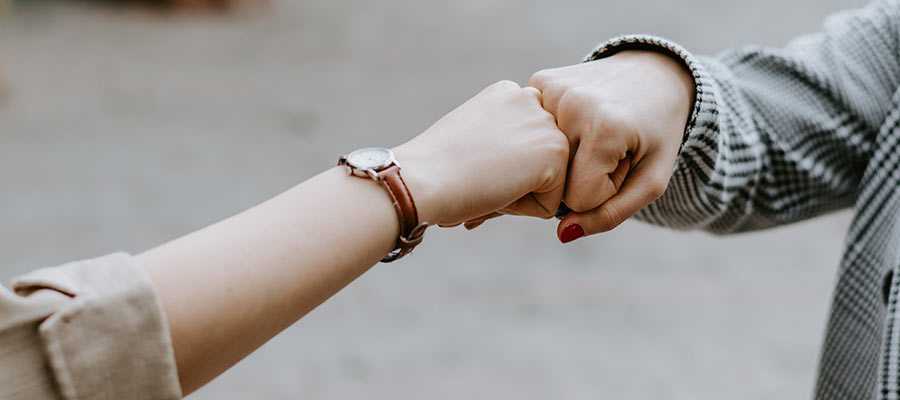 Two people engaging in a fist bump.