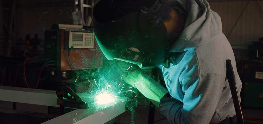 Factory worker welding.