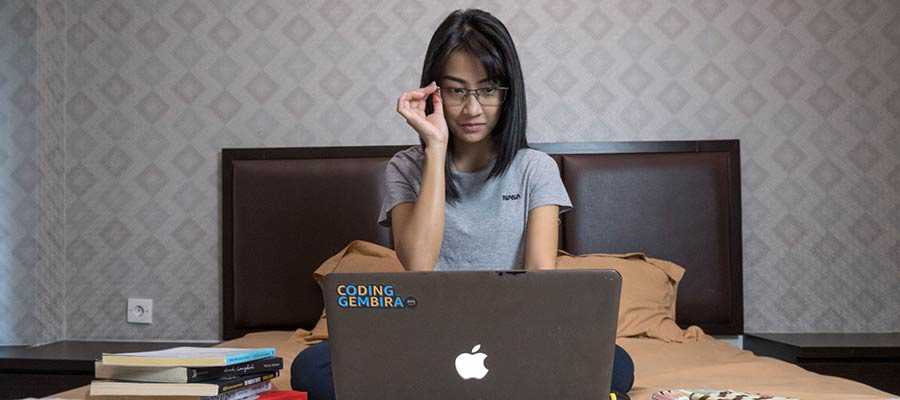 A woman works at a computer.