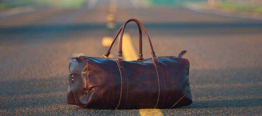 A suitcase sitting on a road.