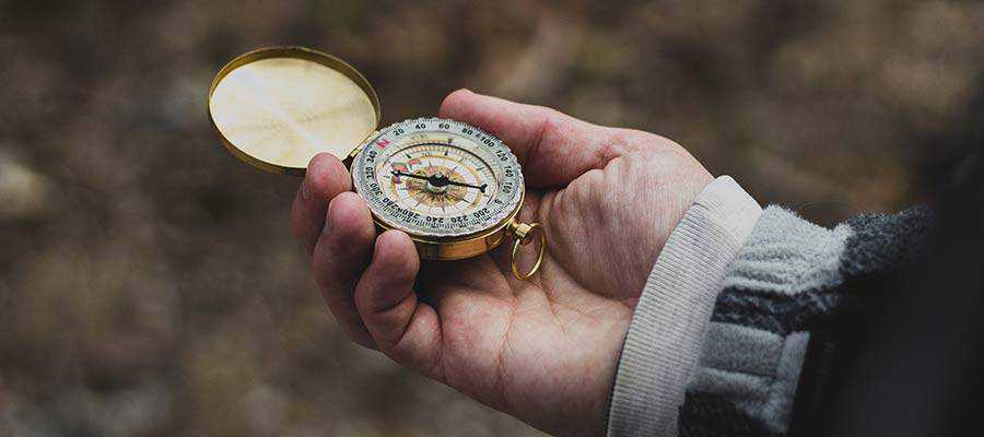 A person holding a compass.