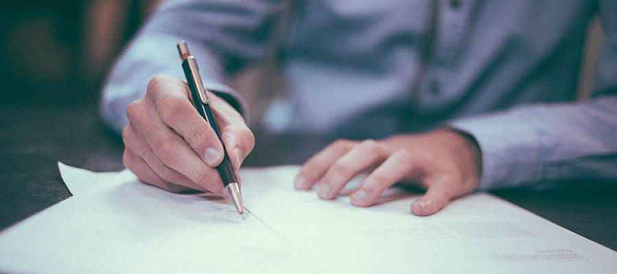 A person signing a document.